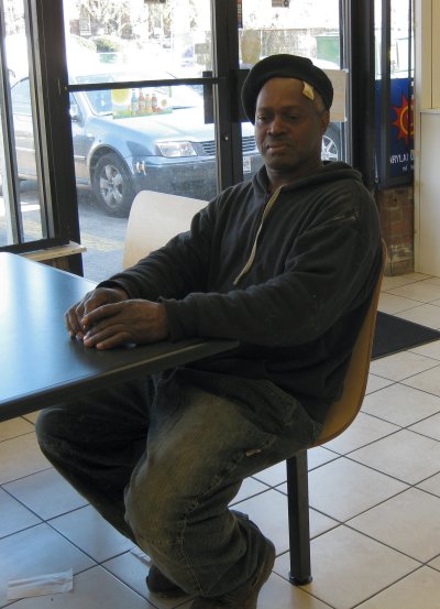 George Dennis sits patiently waiting for his food in a carry-out/convenience store in Park Heights. (Photo: Sam Schmieder)