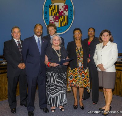 Pictured (left to right), Commissioner Bobby Rucci (District 4); Commissioner Vice President Reuben B. Collins, II (District 3); Commissioner Ken Robinson (District 1); Eleanor Nelson, (director, Job Match Re-Employment Project); Sheron Henry, (participant, Job Match Re-Employment Project); Commissioner Debra M. Davis, Esq. (District 2); and Commissioner President Candice Quinn Kelly.