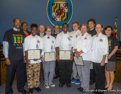 Pictured (left to right): Commissioner Vice President Reuben B. Collins, II (District 3); Commissioner Debra M. Davis, Esq. (District 2); Shareon Blenman (culinary arts student); Michael Simms (North Point High School principal); Kacie Danek (culinary arts student); Commissioner Bobby Rucci (District 4); Demisha White (culinary arts student); Will Remik (culinary arts student); Pamela Jones (culinary arts chef instructor); Commissioner Ken Robinson (District 1); Kat Dodson (culinary arts chef assistant) and Commissioner President Candice Quinn Kelly.