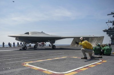 ATLANTIC OCEAN (Aug. 17, 2014) The Navy's unmanned X-47B launches from the aircraft carrier USS Theodore Roosevelt (CVN 71). The aircraft completed a series of tests demonstrating its ability to operate safely and seamlessly with manned aircraft. Three days later, 175 unmanned systems experts from the military, government, academia, and private industry participated in Naval Surface Warfare Center Dahlgren Division's first Unmanned Systems Integration Workshop and Technical Exchange Meeting. The integration of autonomous unmanned aircraft systems, such as the unmanned X-47B, in the aircraft carrier control area was discussed at the event. "Integrating unmanned systems into the Fleet has always been the biggest challenge", said Ajoy 'AJ' Muralidhar, NSWCDD Human Systems Integration engineer and the event's lead organizer. "Technology hurdles can be overcome, but true unmanned systems integration requires us to alter our entire approach to war fighting to obtain the maximum benefit from the new capabilities". (U.S. Navy photo/Released)