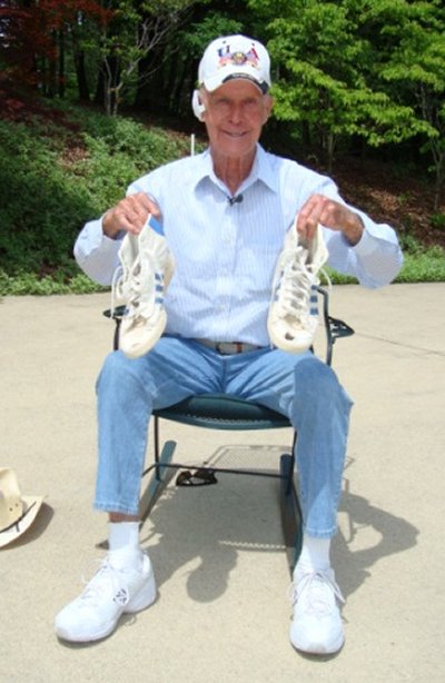 Former State Senator Bernie Fowler. displays his wade-in sneakers on the bank of the Patuxent River (Photo: Maryland Department of Planning)