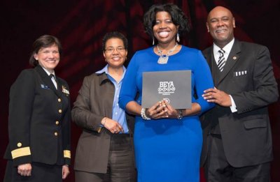 Tiffany Owens, Naval Surface Warfare Center Dahlgren Division (NSWCDD) systems safety engineer, holds her certificate after being honored with the 2015 Modern-Day Technology Leader Award at the 29th annual Black Engineer of the Year Awards (BEYA) gala. Standing left to right are Rear Adm. Anita Lopez, Deputy Director of the National Oceanic and Atmospheric Administration Commissioned Officer Corps; Dr. Kendall Harris, Dean of Prairie View A&M University's College of Engineering; and Dr. Robin Coger, Dean of North Carolina A&T State University's College of Engineering.