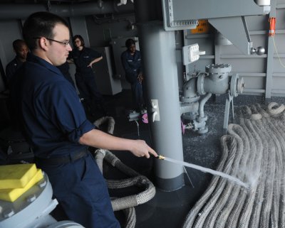 Then U.S. Navy Boatswain's Mate Seaman Robert Mange conducts periodic maintenance on mooring lines aboard the aircraft carrier USS George H.W. Bush (CVN 77) in the Atlantic Ocean on May 16, 2013. Mange was reportedly active duty until Sept. 2014. (U.S. Navy photo by Mass Communication Specialist Seaman Joshua Card/Released)