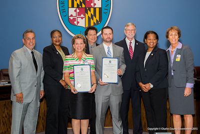 The Charles County Commissioners, joined by Superintendent Kimberly Hill, congratulate Charles County Public Schools principal and teacher award recipients. (l. to r.: Commissioner Bobby Rucci (District 4); Commissioner Debra M. Davis, Esq. (District 2); Thadine Wright; Commissioner Vice President Ken Robinson (District 1); Allen Hopkins, Jr.; Commissioner President Peter F. Murphy; Commissioner Amanda M. Stewart, M. Ed. (District 3); and Dr. Kimberly Hill, superintendent of Charles County Public Schools.