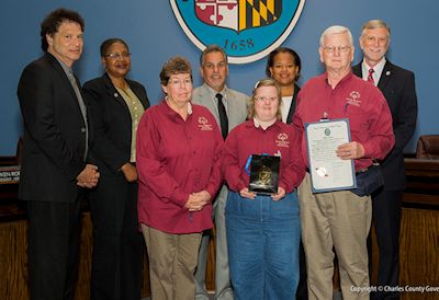 Pictured above front row (left to right): Commissioner Vice President Ken Robinson (District 1); Commissioner Debra M. Davis, Esq. (District 2); Marilyn Borrell, Special Olympics Charles County; Commissioner Bobby Rucci (District 4); Christine Hoehl, Special Olympics Charles County; Commissioner Amanda M. Stewart, M.Ed. (District 3); George Hoehl, Special Olympics Charles County; and Commissioner President Peter F. Murphy.