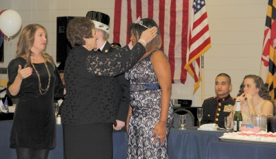 Board of Education Chairman Virginia McGraw, pictured second from left, crowns St. Charles High School senior Taylor Bell, pictured right, as queen of the Col. Donald M. Wade Joint Services Military Ball. Also pictured is Traci Chappelear, left, coordinator of career and technology education for Charles County Public Schools.