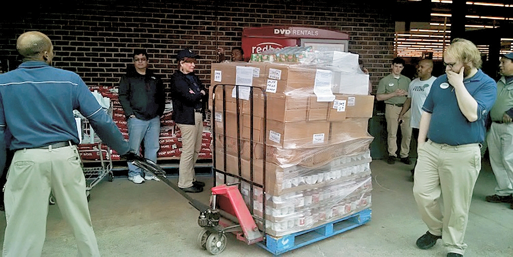 Food Lion employees at the Charlotte Hall store wheel out a pallet of food. The store donated $1,000 worth of product to the cause. (Photo courtesy of St. Mary's Co. Gov.)