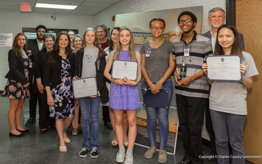 Pictured with Commissioner President Peter F. Murphy and Commissioner Ken Robinson (District 1) are local artist and teacher Vicki Marckel and Henry E. Lackey High School art students. (Photo: Charles Co. Gov.)