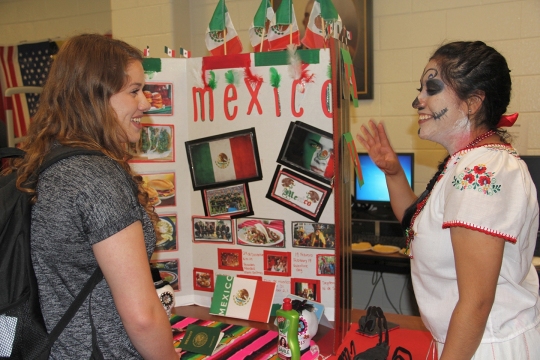 Ana Chavez, right, a junior at Maurice J. McDonough High School, talks to freshman Lauren Haley about Mexico's Dead of the Dead.