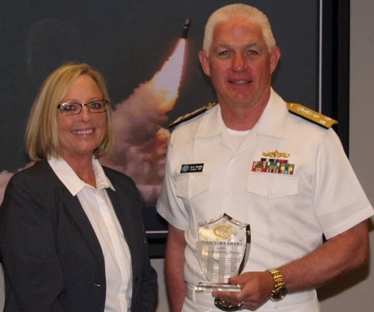 WASHINGTON (June 2, 2016) Navy Strategic Systems Programs (SSP) Director Vice Adm. Terry Benedict presents the SSP Director's Award to Naval Surface Warfare Center Dahlgren Division (NSWCDD) senior scientist Kim Payne for leadership impacting the Fleet Ballistic Missile Program. Payne was honored for her expertise in fire control software and targeting models as well as quality assurance methodology enhancements to improve Fleet Ballistic Missile deployed software product effectiveness and efficiency. Benedict said her efforts, "directly contributed to the Fleet Ballistic Missile Program and successful SSGN (Ohio-class guided-missile submarine) conversion software initiatives." (U.S. Navy photo/Released)