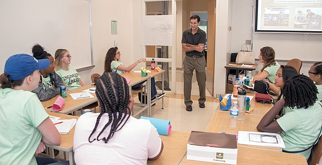 Dr. David John Barrett of the Southern Maryland Pathways Program in Engineering, center, talks with the young women attending "Engineer Like a Girl" camp at CSM's Leonardtown Campus. Clockwise from Barrett, right, are Elizabeth Trossbach, Isabella Corradi, Victoria De Jesus, Gabrielle Moore, Keiana Gray, Jamie DeWaters, Ma'Lani Wilson, Sierra Fowler and Riley Hines.