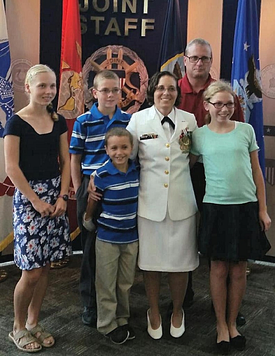 SUFFOLK, Va. - Karen Wingeart is pictured with her family upon her recent retirement from the Navy reserves. NAVSEA Commander Vice Adm. Thomas Moore announced Wingeart as the award winner in an April 2017 communiqué to NAVSEA employees based at Navy warfare centers and shipyards across the country. The Women Moving Forward award recognizes the contributions of individuals who promote equal opportunity in the workforce and continually make significant positive impacts to the command's mission and readiness. Wingeart - a the Navy's expert on Cooperative Engagement Capability systems for Ship Self-Defense Systems - served as a surface warfare officer and a meteorology and oceanography officer in her 20-year Navy career - 11 years on active duty and nine years in the reserves.