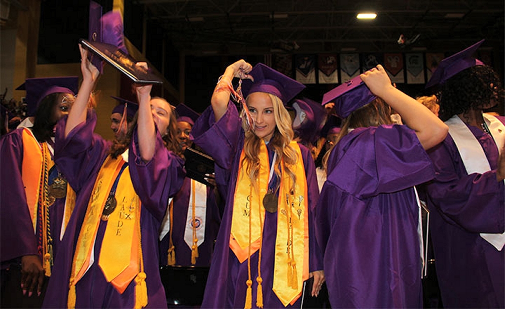 Morgan Akers, center, a 2017 graduate of Maurice J. McDonough High School, turns her tassel at the conclusion of commencement ceremonies June 3. (Photo: CCPS)