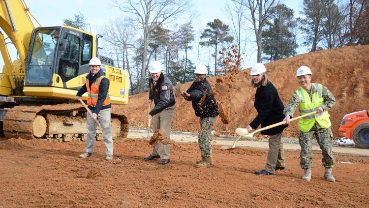From left, Greg Ferenschak, project manager for Harkins Builders; Capt. Jason Hammond, NAS Patuxent River commanding officer; Pax River Command Master Chief Kevin Guy; Ross Keene, Pax housing director; and Cmdr. Grant Watanabe, Public Works officer, break ground Dec. 12 on the new single enlisted quarters barracks located at the corner of Buse and Cuddihy Roads. (U.S. Navy photo by Patrick Gordon)