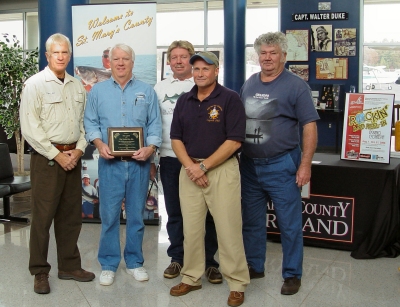 Ken Lamb of the Tackle Box, Inc., receives a plaque from St. Mary’s charter captains James Gray, Greg Madjeski, Phil Langley and Stan Harris, for sponsorship of the Rockin’ and Reel-in fishing contest.