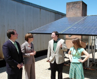 Randy Larsen (third from left), a chemistry professor at St. Mary's College of Maryland, shows the college library's solar panels to Eric Daniels (left), chief technology officer for BP Solar on Earth Day. The college announced it would become the first school of higher education in Maryland to offset 100% of its electricity with 'green energy' credits. Also pictured is Maggie O'Brien, the college's president (2nd from left) and Rachel Clement (far right), co-president of the student's environmental action coalition. A student-led referendum overwhelmingly supported funding the purchase of energy credits from student fees. Photo by Robin Kendall.