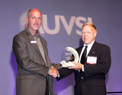 Daryl Davidson, AUVSI Foundation executive director, presents the Member of the Year award to Jim Curry (right). (Submitted photo)