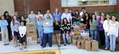 Event organizers, center from left, Robin Lamphier, Juliet Hoey, Allison Denikos and Connie Churchward were joined by Leonardtown Campus students who helped load the donations onto the Southern Maryland Food Bank truck prior to Thanksgiving. (Submitted photo)