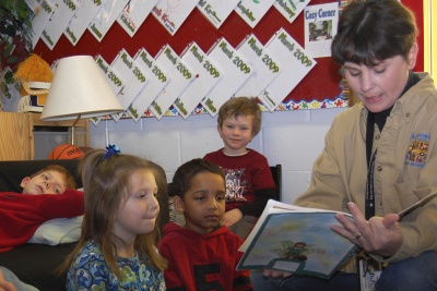 Susan Newton, recipient of a CSM grant funding students pursuing degrees in early childhood education, reads to Jack Lindner, left, and back, Lauren Murphy, Jahci Knick and David Morris at the Prime Time Children’s and Youth Activity Center in Owings. (Submitted photo)