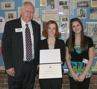 Milton M. Somers Middle School language arts teacher Stephanie Harris, pictured center, receives a John Hopkins Center for Talented Youth Sarah D. Barder Fellow recognition certificate from Charles Rowins, deputy to the executive director, pictured left. Harris was nominated for recognition through the CTY program by Somers eighth grader Jessica Burroughs, pictured right. (Submitted photo)