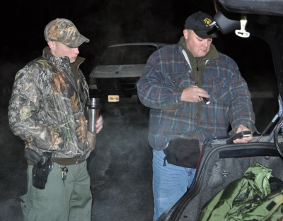 Officer Drew Wilson and Cpl. Roy Rafter with the Natural Resources Police look up latitude and longitude coordinates on a GPS device Feb. 24. (Capital News Service Photo by Kerry Davis)