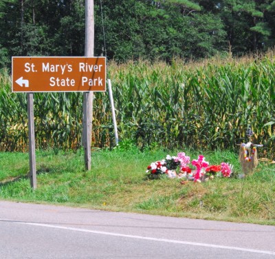 Friends and family have laid memorials at the location where their loved ones perished on August 4 after being struck head-on. Tire marks and paint from the police investigation can still be seen on the roadway six days later. (Photo: David Noss on 10-AUG-2011)
