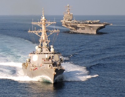 The guided-missile destroyer USS Ross (DDG 71) and the aircraft carrier USS Abraham Lincoln (CVN 72) cruise in a formation in the Gulf of Oman in 2010. When Naval Surface Warfare Center Dahlgren Division engineers installed the Joint Biological Point Detection System aboard USS Ross in September 2011, it became the 50th ship in the Fleet upgraded with near real time biological warfare agent detection, warning, identification and sample isolation capabilities. (U.S. Navy photo by Mass Communication Specialist 3rd Class Colby K. Neal/Released)