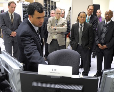 Phil Irey, lead computer scientist at the Dahlgren Division of the Naval Surface Warfare Center, explains to Department of the Navy officials the Office of Naval Research's suite of information technology tools designed to improve fleet operations during a series of experiments at the Integrated Warfare Systems Laboratory in Dahlgren, Va. The centerpiece of the effort is a "universal gateway" system designed to pass data securely and swiftly between a ship's combat system network and its command-and-control network. (U.S. Navy photo by John F. Williams/Released)