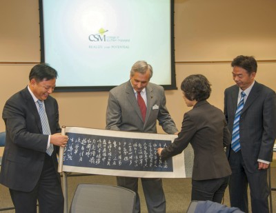 CSM President Dr. Brad Gottfried, center, receives a gift from members of a delegation of presidents and vice presidents from vocational and technical institutions from across China who visited CSM earlier this fall to learn about the American community college model. (Photo: CSM)