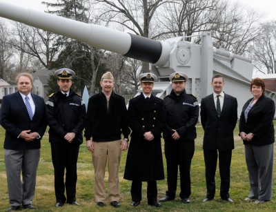 Naval Surface Warfare Center Dahlgren Division and U.K. military officials pause in front of the static 16-inch gun – a landmark on the Dahlgren parade field – during the U.K. delegation’s tour of NSWCDD laboratories and its research, development, test and evaluation facilities in February. U.K Royal Navy Commodore Alex Burton led the delegation who engaged Dahlgren scientists and engineers in discussions and learned more about U.S. technological programs and capabilities, including directed energy weapons, the Littoral Combat Ship Gun Mission Module, the Electromagnetic Railgun and the Potomac River Test Range.