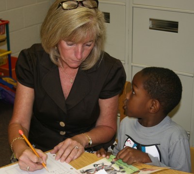 Mary Bailey, pictured left, a Reading Recovery teacher at Dr. Thomas L. Higdon Elementary School, works with kindergartner Omari Cole, pictured right, during a reading lesson. Bailey, who works with students in grades kindergarten through second, was named the 2013 Charles County Public Schools Teacher of the Year.