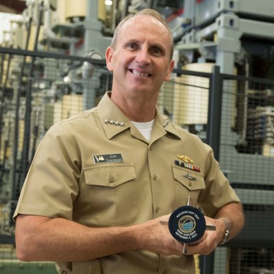 DAHLGREN, Va. (Sept. 4, 2014) - Chief of Naval Operations (CNO) Adm. Jonathan Greenert displays half of an Electromagnetic Railgun projectile customized with a command coin commemorating Greenert's visit to Naval Surface Warfare Center Dahlgren Division where he was briefed and shown demonstrations of the railgun, Real-Time Spectrum Operations and the Laser Weapons System (LaWS). During his visit, Greenert also held an all-hands call with Naval Support Facility South Potomac Sailors, civilians and family members to discuss the current and future status of the Navy. (U.S. Navy photo by Chief Mass Communication Specialist Peter D. Lawlor/Released)