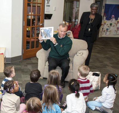 St. Charles Children’s Learning Center Director Shirley Allen, standing, looks on as students enjoy preschool activities and special celebrity readers, such as SMECO President and CEO Austin J. Slater Jr.