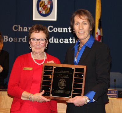 Superintendent of Schools Dr. Kimberly Hill, right, presents longtime Board of Education member Roberta S. Wise, left, with the James E. Richmond Leadership Excellence Award at a Dec. 9 meeting. Wise was honored with the award for her leadership while serving two terms on the Board. 