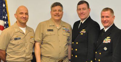 NSWCDD Commander Capt. Brian Durant is pictured with three of the command's civilian employees who chose to wear their Navy uniforms in honor of this significant milestone. Standing left to right are Capt. Durant; Lyle Brown, an NSWCDD Warfare Systems Department physicist; Robert Getty, an Engagement Systems Department lead systems engineer; and Mark Pugh, a Warfare Systems Department physicist.