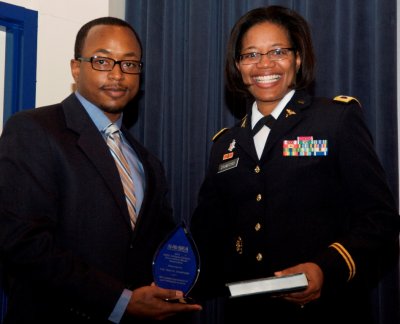 Michael Hobson, Naval Surface Warfare Center Dahlgren Division (NSWCDD) Black Employment Program manager, presents a plaque to his sister - Col. Traci Crawford, commander of Moncrief Army Community Hospital, Fort Jackson, S.C. - in grateful appreciation of her willingness to serve as guest speaker at the NSWCDD sponsored 2015 Black History Month Observance aboard Naval Support Facility Dahlgren Feb. 26. (U.S. Navy photo by Patrick Dunn/Released)