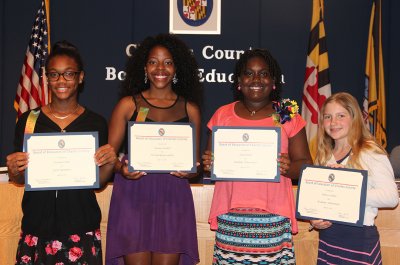 Four Charles County Public Schools students were honored by the Board of Education at their May 12 meeting for accomplishments in the area of academic achievement, personal responsibility and career readiness. Pictured from left are Jasmine Forbes from Mattawoman Middle School, Desiree Satchell from North Point High School, Zaria Smith from Mary B. Neal Elementary School and Rebecca White from Walter J. Mitchell Elementary School.