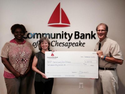 From left to right: Community Bank of the Chesapeake Assistant Vice President and La Plata Branch Manager Teresa Roach, and Executive Vice President and Director of Sales Rebecca J. Henderson present the check for $250 to Charles County Arts Alliance Interim Treasurer and Scholarship Committee Co-chair Ronald Brown.
