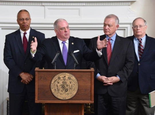Gov. Hogan, with his hair clearly coming back, explains his budget proposal at a Thursday press conference. Left is Lt. Gov Boyd Rutherford, on the right is Budget Secretary David Brinkley and fiscal advisor Bob Neall.