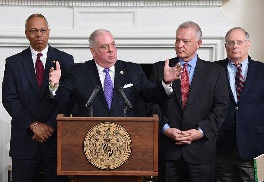 Gov. Larry Hogan explains his budget proposal at a Jan. 7 press conference. Left is Lt. Gov Boyd Rutherford, on the right is Budget Secretary David Brinkley and fiscal advisor Bob Neall. Hogan won't be talking about the budget when he releases it Wednesday.