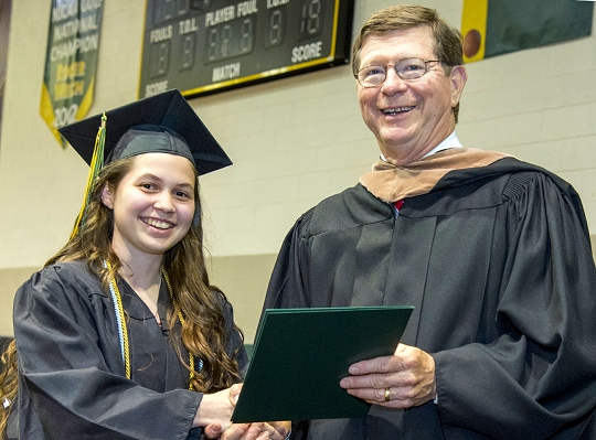 Kaylin Beach of Pomfret, left, is congratulated by former CSM Trustee Chair Mike Middleton during the College of Southern Maryland May 2015 Commencement Ceremony. Beach earned a degree in elementary education and enrolled in the 2+2 Program with Towson University to complete her bachelor's degree.