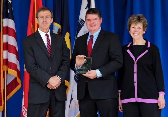 WASHINGTON (June 22, 2016) - Dr. Christopher Weiland, holding the 2015 Dr. Delores M. Etter Top Scientists & Engineers of the Year Award for exceptional scientific and engineering achievement, is flanked by Assistant Secretary of the Navy for Research, Development and Acquisition Sean Stackley and the award's namesake. Etter, a former Assistant Secretary of the Navy for Research, Development and Acquisition joined Stackley to present the award to recipients at a Pentagon ceremony. Weiland - a Naval Surface Warfare Center Dahlgren Division engineer - was one of three recipients in the award's Emergent Investigator Category. He was honored for developing a system that augments naval gunfire capabilities by using unmanned aerial vehicles as additional shipboard sensors. His project eliminates risks in training scenarios and allows U.S. warships to quantitatively train and score gun crews anywhere in the world. (U.S. Navy photo/Released)