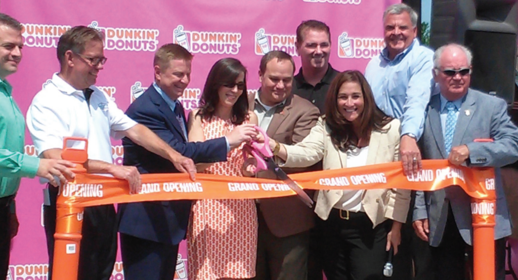 Franchise operator, Maria Icaza, cuts the ceremonial ribbon of the new store in Leonardtown alongside local dignitaries. (Photo: St. Mary's County Times)
