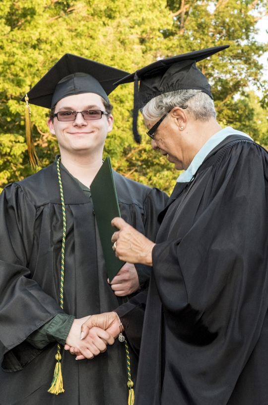 James Walls of Hughesville has earned a University System of Maryland Board of Regents scholarship to attend the University of Maryland, Baltimore County. Walls, left, receives his associate's degree from Dorothea Holt Smith, chair of the CSM Board of Trustees, during the spring 2016 commencement ceremonies.