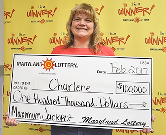 Charlene displays her ceremonial check for $100,000. She elected to not publicly release her last name.
