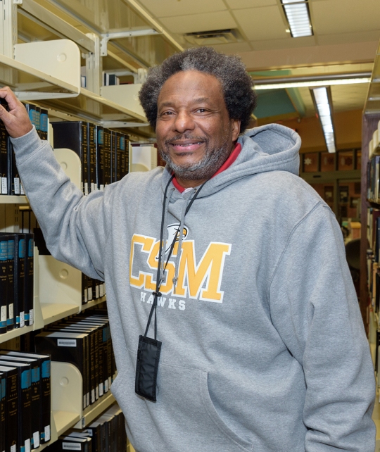 CSM student Benjamin Brown checks out the law books at a CSM library. Brown, a retiree, is working toward his associate degree at CSM with the ultimate goal of earning his law degree and becoming an attorney.