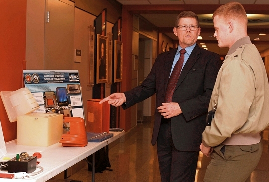 ARLINGTON, Va. (March 15, 2017) - Mark Blocksom, left, the deputy department head of fleet and logistics support, SPAWAR Systems Center Pacific, discusses innovative 3D printing solutions to everyday military operations with Cpl. Christopher Bigham, from Waldorf, Md., during the Department of the Navy's 2017 3D Print-a-Thon expo at the Pentagon. Twenty DoN organizations - including scientists and engineers from the Naval Research and Development Establishment, maintenance operations, and Marines and Sailors from multiple commands - presented items produced through the use of Additive Manufacturing technology. Naval Surface Warfare Center Dahlgren Division coordinated the event, sponsored by the deputy assistant secretary of the Navy for research, development, test and evaluation. (U.S. Navy photo by Mass Communication Specialist 2nd Class Alex L. Smedegard/Released)