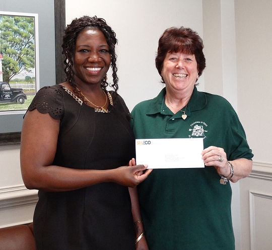 On behalf of CoBank, SMECO's community and public affairs director Natalie Cotton (left) presents a $1,500 contribution to Darene Kleinsorgen, Executive Director of Christmas in April St. Mary's County. Matching contributions were also given to Christmas in April organizations in Calvert and Charles counties.
