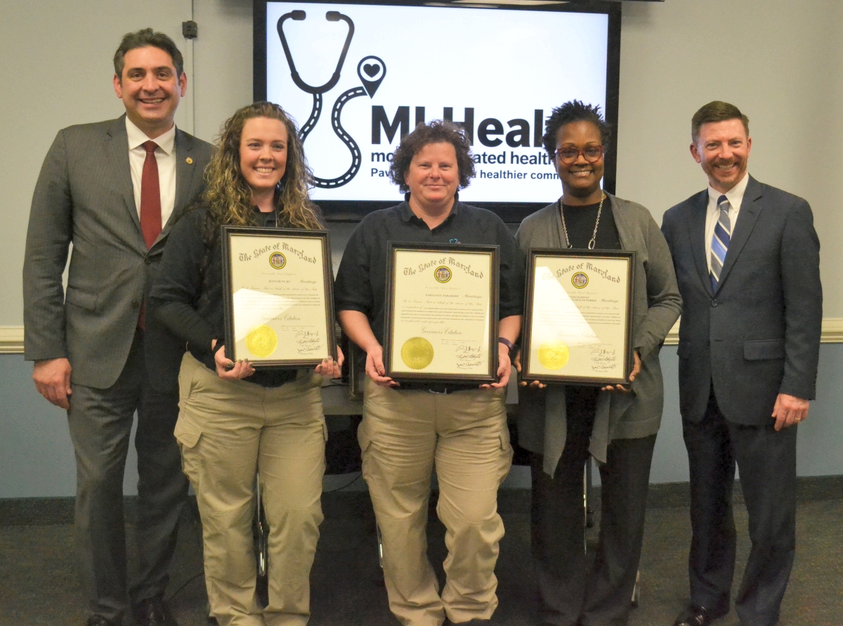 Charles County Mobile Integrated Healthcare team members, Jenny Hunt, registered nurse; Pam Gantt, paramedic; and Wanda Mahoney, community health worker receive the Governor’s Customer Service Heroes Award from representatives of the Governor Larry Hogan’s Office: Gregory M. Derwart, managing director of Administration and Customer experience (far left); Michael Morrello, director of the Governor’s Office of Performance Improvement (far right).