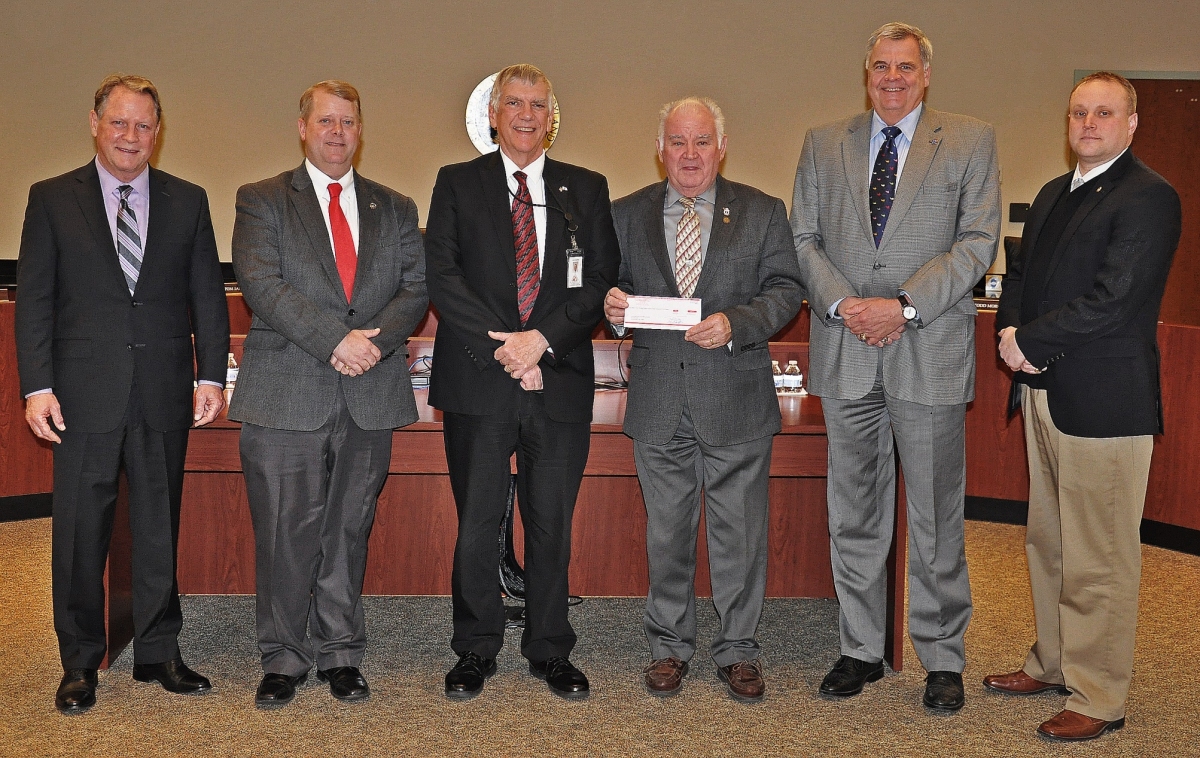 Pictured (front, l-r):  Commissioner Mike Hewitt, Commissioner Tom Jarboe, John Hartline, Tri-County Council Executive Director, Commissioner President Randy Guy, Commissioner Todd Morgan and Commissioner John O'Connor accept check donation from Tri-County Council of Southern Maryland. (Photo courtesy of the county government)
